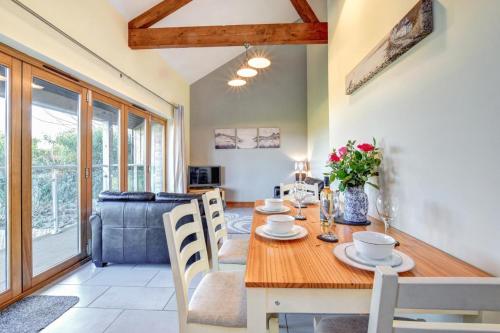 a dining room with a wooden table and chairs at 2 Bed in Cardiff oc-91710 in Cardiff