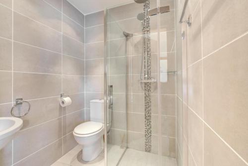 a bathroom with a shower with a toilet and a sink at 2 Bed in Cardiff oc-91710 in Cardiff