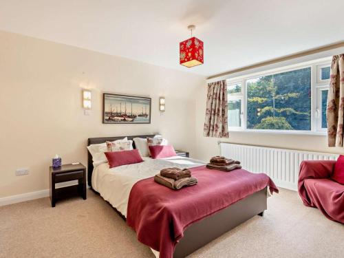 a bedroom with a large bed and a window at 4 Bed in Peterborough oc-93450 in Yaxley