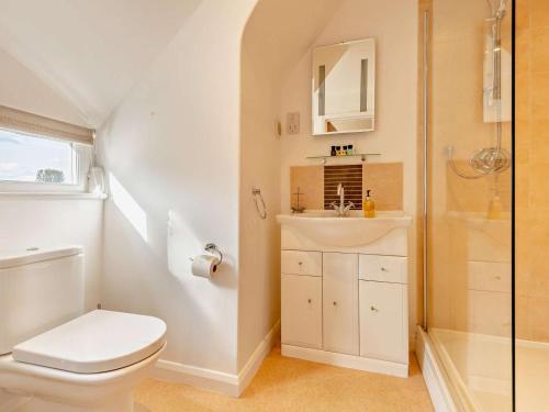 a bathroom with a toilet and a sink and a shower at 4 Bed in Peterborough oc-93450 in Yaxley
