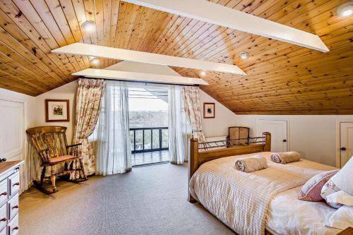 a bedroom with two beds and a large window at 4 Bed in Builth Wells oc-bow197 in Builth Wells