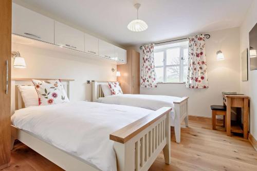 a bedroom with two beds and a window at 2 Bed in Gilwern oc-o27004 in Gilwern