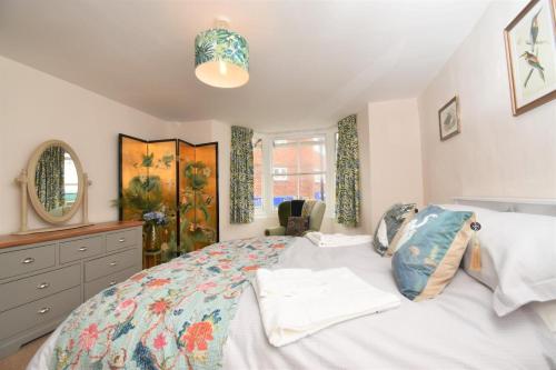 a bedroom with a large bed and a dresser at 4 Bed in Seaton oc-s27403 in Seaton