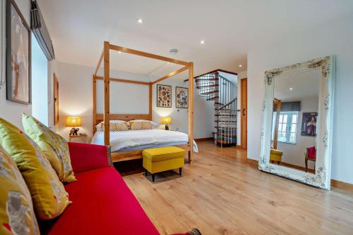 a bedroom with a bed and a red couch at 1 Bed in Werrington oc-c29073 in Werrington