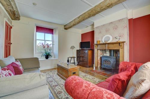 a living room with a couch and a fireplace at 3 Bed in Little Walsingham oc-1386 in Little Walsingham