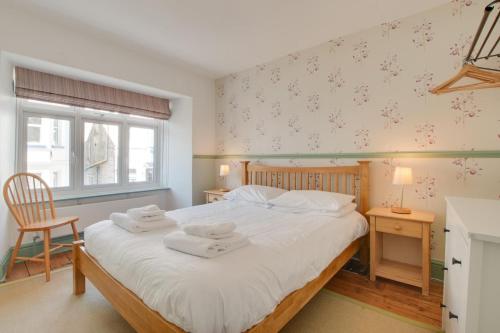 a bedroom with a large bed with towels on it at 3 Bed in Beer oc-jbgall in Beer