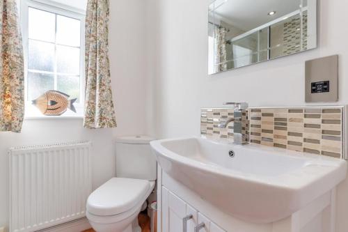 a white bathroom with a sink and a toilet at 1 Bed in Halam oc-o32227 in Edingley