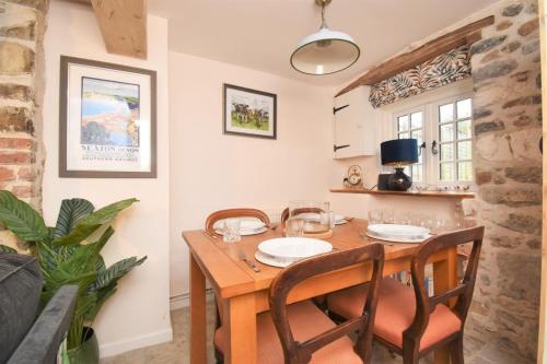a dining room with a wooden table and chairs at 2 Bed in Seaton oc-b27402 in Seaton