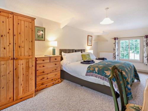 a bedroom with a bed and a wooden dresser at 2 Bed in Alford oc-94226 in Great Carlton