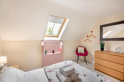 a bedroom with a bed and a window and a red chair at 1 Bed in Berwick-upon-Tweed oc-a32026 in Kyloe
