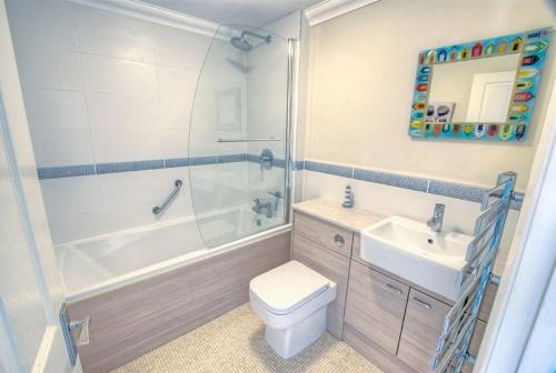 a bathroom with a toilet and a sink and a shower at 2 Bed in Seaton oc-mbtuc in Seaton