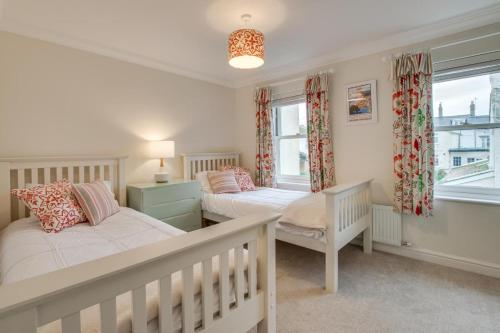 a bedroom with two beds and a window at 2 Bed in Seaton oc-mbtuc in Seaton