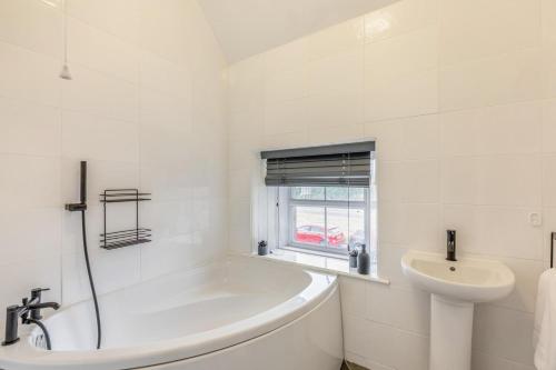 a white bathroom with a tub and a sink at 2 Bed in Berwick-upon-Tweed oc-l32027 in Kyloe
