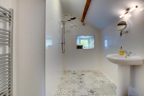 a white bathroom with a shower and a sink at 4 Bed in Ruthin oc-bow136 in Gwyddelwern