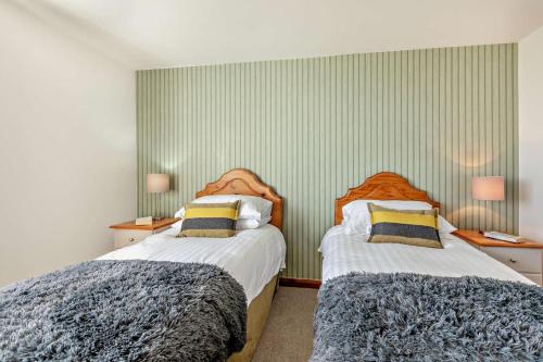 a bedroom with two beds and two night stands at 1 Bed in Blue Anchor oc-b28904 in Blue Anchor