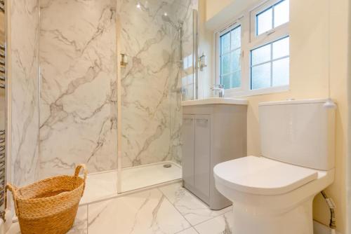 a white bathroom with a toilet and a shower at 3 Bed in Southwell oc-s30603 in Southwell