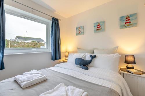 a bedroom with a bed with a stuffed elephant on it at 2 Bed in Brixham oc-f28884 in Brixham