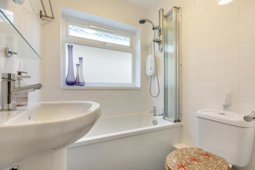 a bathroom with a sink toilet and a window at 2 Bed in Brixham oc-f28884 in Brixham