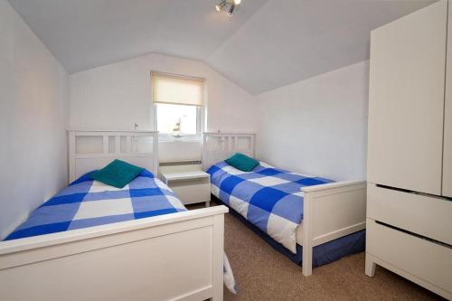 a bedroom with two beds and a window at 2 Bed in Pwllheli oc-glanab in Abersoch