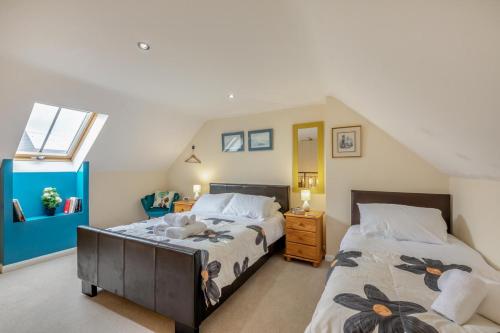a attic bedroom with two beds and a window at 1 Bed in Berwick-upon-Tweed oc-b32029 in Kyloe
