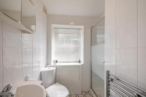 a white bathroom with a toilet and a window at 1 Bed in Berwick-upon-Tweed oc-c32028 in Kyloe