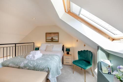a bedroom with a bed and a green chair at 1 Bed in Berwick-upon-Tweed oc-c32028 in Kyloe
