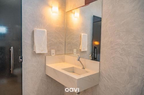 a bathroom with a sink and a mirror at Villa Kaitei in São Miguel do Gostoso