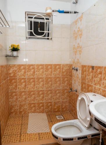 a bathroom with a toilet and a sink at Perfect Palm Condos-P2 in Nakuru