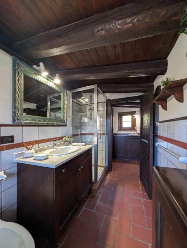 a bathroom with two sinks and a mirror at Azure Bay Chic Villa in Fontane Bianche