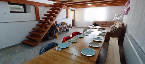 a long wooden table in a living room at Cazare Valea Dinozaurilor in Sibişel