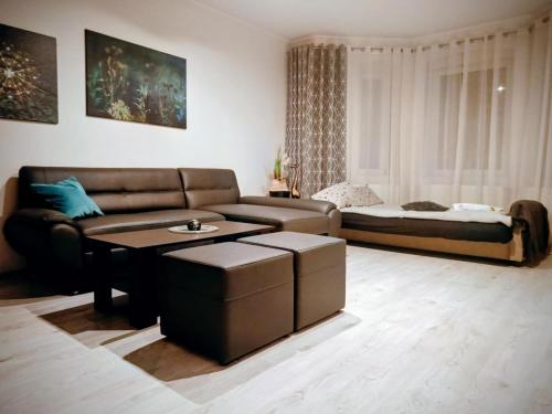 a living room with a couch and a table at APaRTAMENT MOUTAIN SKY in Świeradów-Zdrój