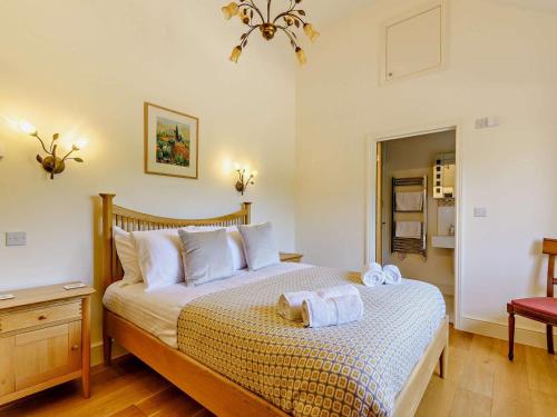 a bedroom with a bed with two towels on it at 3 Bed in Holt oc-83628 in Blakeney