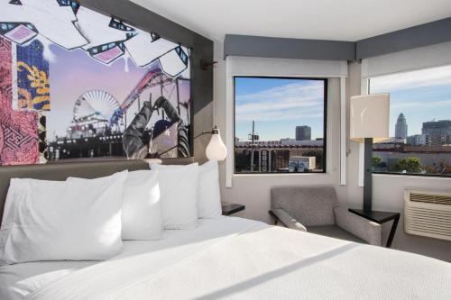 a hotel room with a large bed and a large window at Aiden Los Angeles Downtown Dragon Gate Inn in Los Angeles