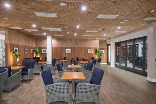 a waiting room with tables and chairs in a building at Aiden Los Angeles Downtown Dragon Gate Inn in Los Angeles