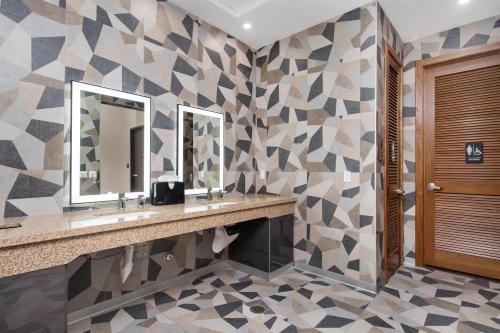 a bathroom with two sinks and a mirror at Aiden Los Angeles Downtown Dragon Gate Inn in Los Angeles