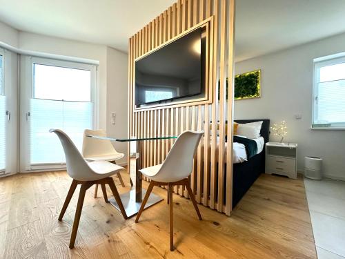 a bedroom with a table and chairs and a bed at YAYstay - comfy Lofts in Rosenheim in Rosenheim