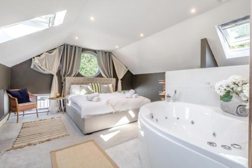 a large bathroom with a tub and a bed at 5 Bed in Blofield oc-s33037 in Blofield
