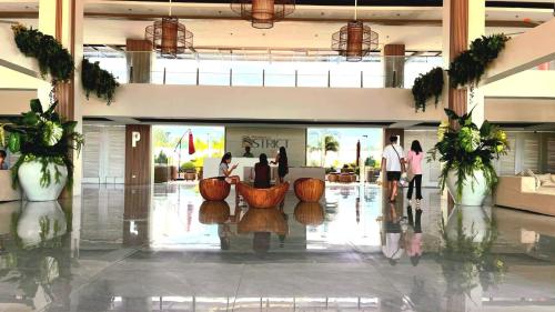a lobby with people walking around in a building at Cara Studio Mactan Cebu Cozy with Garden View at Primeworld District Tower H 103 in Lapu Lapu City