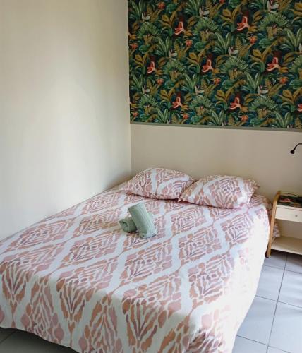 a bedroom with a bed with a stuffed animal on it at Studio confortable au calme - Terrasse privative in Labergement-Foigney