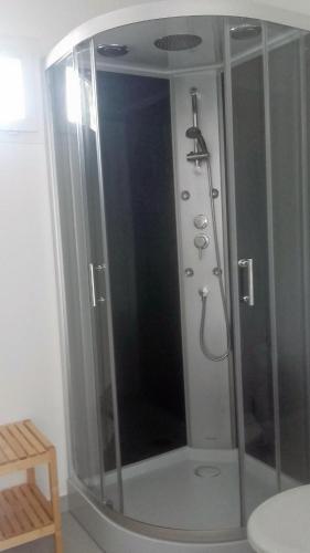 a shower with a glass enclosure in a bathroom at Studio confortable au calme - Terrasse privative in Labergement-Foigney