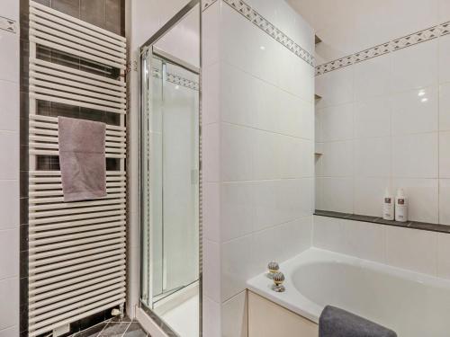 a bathroom with a tub and a glass shower at 4 Bed in Windermere oc-95682 in Winster