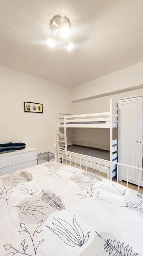 a bedroom with two bunk beds and a large bed at Palazzo Piccolo in Cave del Predil