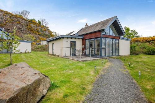 a house with a large rock in the yard at 3 Bed in Bamburgh oc-r30372 in Bamburgh