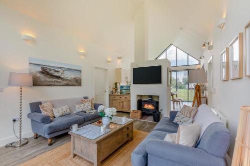 a living room with two blue couches and a tv at 3 Bed in Bamburgh oc-r30372 in Bamburgh