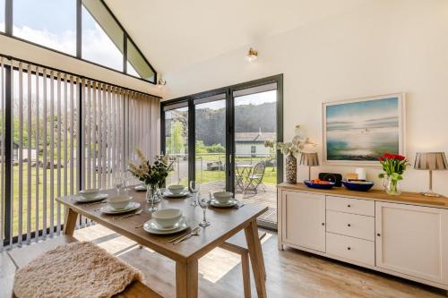 a dining room with a table and large windows at 3 Bed in Bamburgh oc-r30372 in Bamburgh