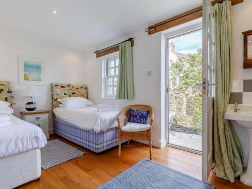 a bedroom with a bed and a window and a sink at 2 Bed in Wadebridge oc-82682 in Little Petherick