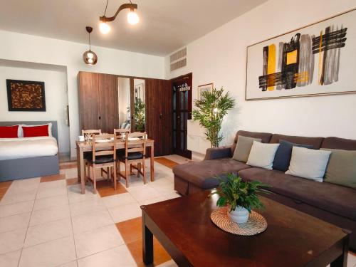 a living room with a couch and a table at One Guest Place Deluxe Room near the Beach in Abu Dhabi