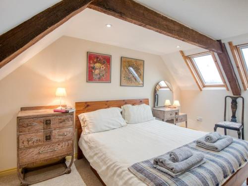 a bedroom with a bed and a dresser and a mirror at 5 Bed in Choseley oc-kt086 in Titchwell