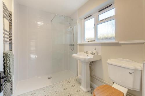 a white bathroom with a shower and a sink at 2 Bed in Ashley oc-c32637 in Ashley