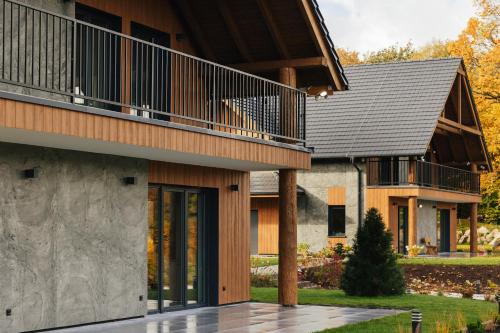 a house with a balcony on top of it at Apartamenty Greenwood in Staniszów
